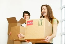 A young man and woman carry out boxes for donations